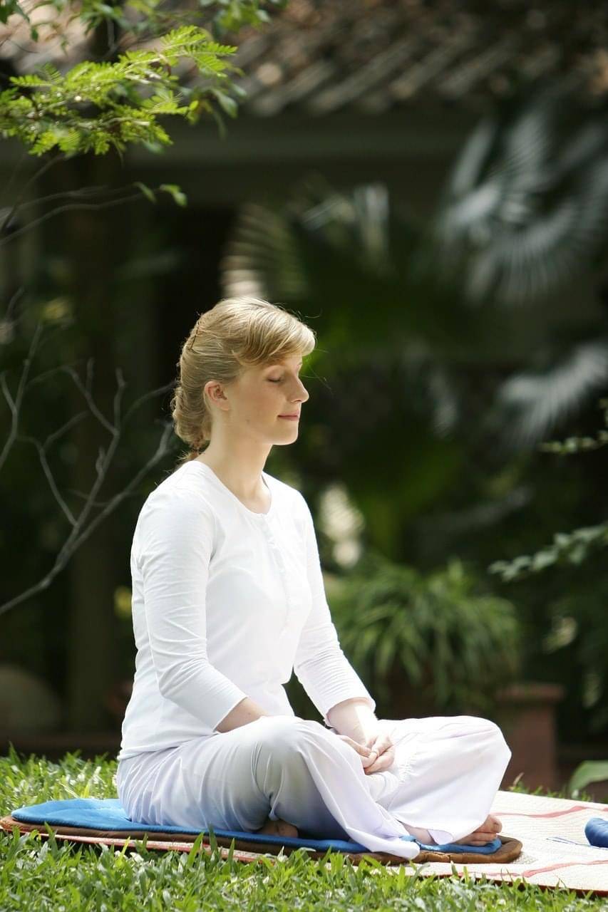 meditator beautiful a woman sitting in a yoga pose
